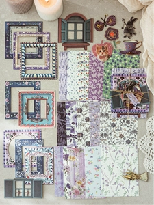 Close-up of vintage purple garden themed scrapbooking supplies with floral cardstock