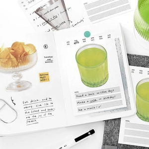 Flat lay of minimalist sticky notes, stickers, and 0.7mm gel pen for DIY scrapbooking