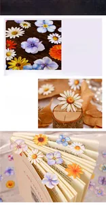 Detail of floral stickers on vintage paper and wood, showcasing die-cut craft and textures