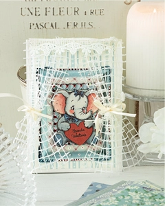 Macro detail of vintage elephant sticker with lace and ribbon for scrapbooking