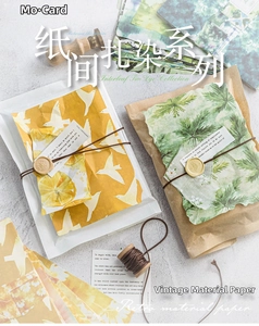 Close-up of vintage tie-dye scrapbooking paper with botanical patterns and twine details