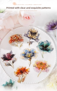 Detailed view of floral PET stickers with gold lace outlines on white porcelain plate