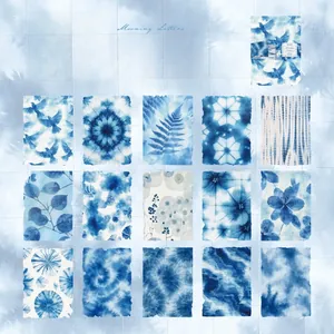 Macro view of blue cyanotype art paper featuring botanical and vintage tie-dye patterns
