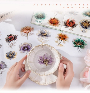 Detailed view of floral PET stickers with gold foil accents on a white porcelain cup
