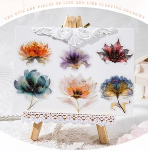 Close-up of floral art stickers set on mini easel with vintage aesthetic props