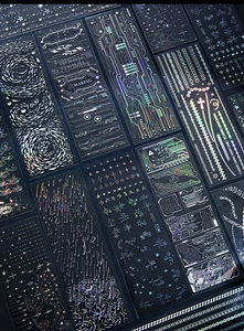 Detail of holographic laser stickers with circuit and starry sky patterns for DIY crafts