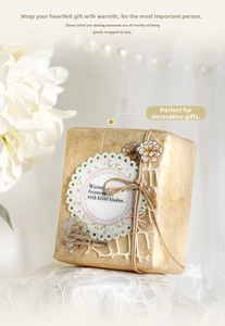 Close-up of vintage lace stickers and twine on kraft paper for DIY scrapbooking