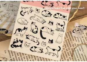 Close-up of cute hand-drawn black and white cat PET stickers for scrapbooking decor