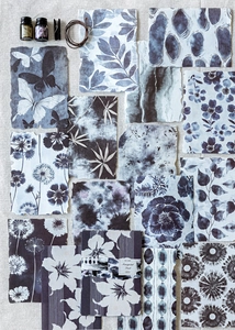 Detail of vintage blue tie-dye scrapbook paper with floral and butterfly patterns