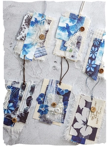 Detail of vintage handmade tie-dye bookmarks with lace, floral fabric and wooden buttons
