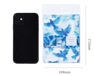 Size reference of vintage blue bird patterned scrapbooking paper with black smartphone