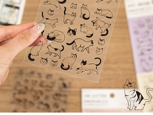 Close-up of transparent PET cat stickers for DIY journals with cute hand-drawn illustrations