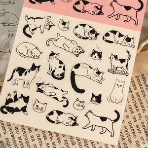 Cute black and white cat PET stickers for journaling, displayed on vintage paper props