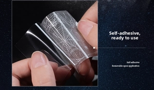 Macro detail showing self-adhesive properties of spider web pattern masking tape for scrapbooking