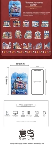 Detailed PET Christmas stickers featuring snowy street lamps and festive European buildings