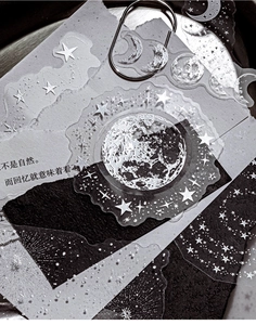 Detail of transparent celestial PET stickers featuring moon phases and stars for journaling