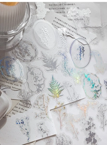 Detailed view of PET stickers with iridescent laser silver floral and frame patterns