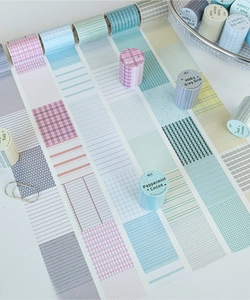 Detail of grid and dot washi tape rolls in soft pastel tones for journaling decoration