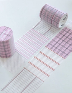 Detail view of pink and apricot grid washi tape with geometric patterns for journaling