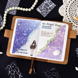 Brown leather journal cover featuring shimmering purple water-themed stickers and collage