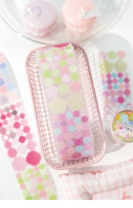 Floral and geometric PET tapes in macaron colors displayed in a decorative wire basket