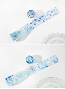 Close-up of blue geometric PET tape with raindrop and dot patterns for scrapbooking