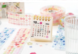 Close-up of decorative PET tape with geometric floral patterns and a mini desk calendar