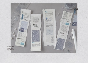 Detailed close-up of vintage PET tape strips with poetic phrases and hand-drawn illustrations