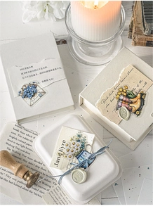 Detail of vintage flower PET stickers and poetic text on retro envelopes with wax seal