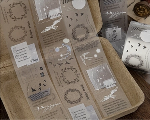 Detail of vintage PET decorative tape with bird, floral wreath and handwriting patterns