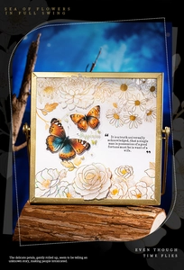 Macro shot of gold square frame sticker featuring butterflies and floral designs