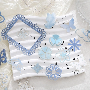 Blue aesthetic paper ephemera kit with butterfly and floral hollow cutouts for scrapbooking