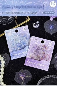 Macro shot of semi-transparent PET firework stickers with glitter finish on black sand