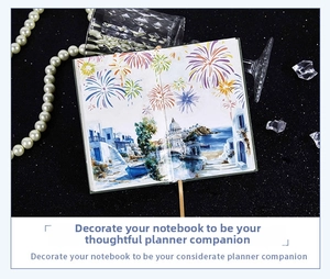 Detail shot of a creative fireworks notebook with gold ribbon bookmark and pearls