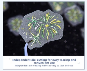 Detail of fireworks glitter sticker with die-cut design being held by tweezers