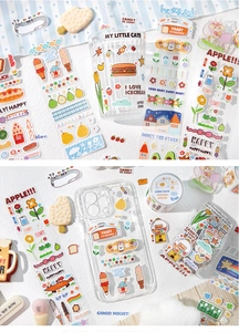 Detailed view of colorful cartoon cat and dessert stickers on phone and glass