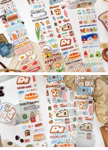 Macro detail of decorative glitter washi tape with breakfast, cat, and fruit patterns