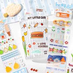 Vertical striped glass cup decorated with cute dessert and animal stickers for journaling