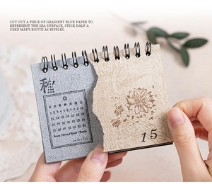 Close-up of retro spiral calendar with floral motifs and weathered paper texture