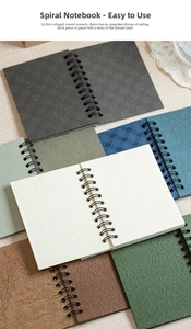 Detail of multi-color spiral notebooks with textured covers and black wire-o binding