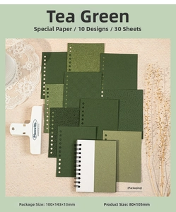 Detail view of tea green textured scrapbook paper set with spiral binding and lace accents