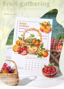 Detail of fruit-themed DIY stickers with calendar elements on a grassy picnic background