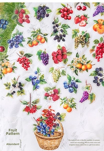 Macro detail of berry themed scrapbook stickers with a basket illustration on marble