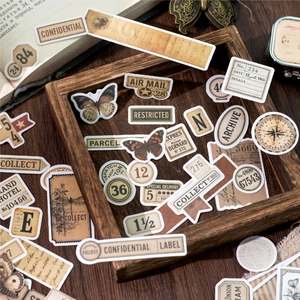 Vintage aesthetic scrapbook stickers set featuring butterflies and retro labels in wooden tray
