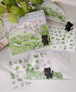 Detailed view of cute black cat PET stickers with floral scene on a bright background