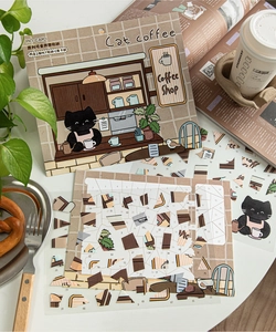 Detail of cute black cat cafe theme PET sticker set with scenery card on white tabletop