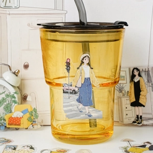 Translucent yellow water bottle with cute cartoon stickers and brown lid for daily use