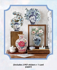 Close-up of PET floral porcelain stickers on dark wood with traditional stationery