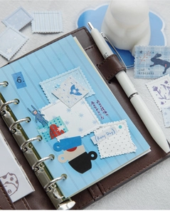 Detail of A6 brown leather binder with vintage stamps and artistic stickers