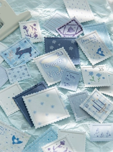 Detail of blue embossed stamp stickers featuring rabbit and floral hand-drawn patterns